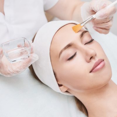 Cosmetology beauty procedure. Young woman skin care. Cosmetology beauty procedure. Young woman skin care. Beautiful female person. Rejuvenation treatment. Facial chemical peel therapy. Clinical healthcare. Doctor hand. Dermatology cleanser.